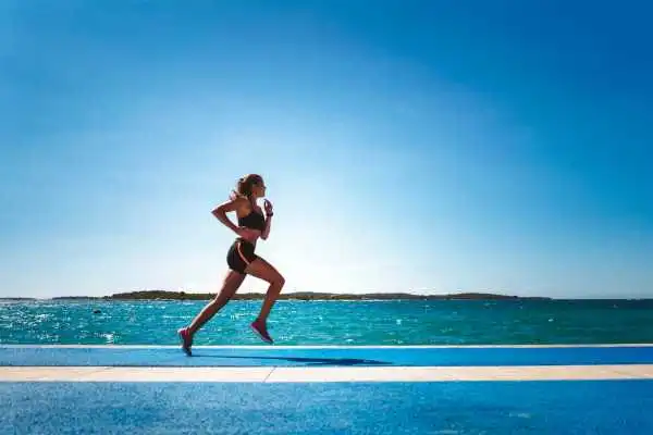 Woman running showing strong leg muscle East Malling